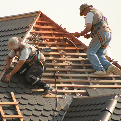 Roofers laying tiles